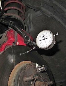 The needle of the dial indicator should be perpendicular to the rotor. Measurements should be taken a quarter inch from the edge. First find the lowest point in the rotor and set the dial indicator to zero. Rotate the rotor to find the high spot. This is the total indicated runout. Mark the high and low spots on the rotor.