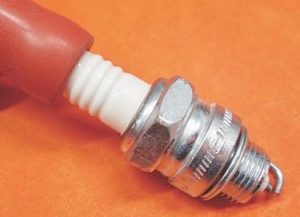 Don’t leave greasy fingerprints on the insulator because they can quickly develop into a carbon-tracking and misfire condition. Do install a length of clean fuel hose or a new spark plug boot on the insulator so it can be properly handled during adjustment and installation.