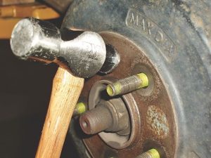Rapping the brake drum between the lug bolts with a two-pound or larger hammer will generally loosen the drum. In some applications, the brake drum incorporates two threaded puller screw holes designed to expedite drum removal.